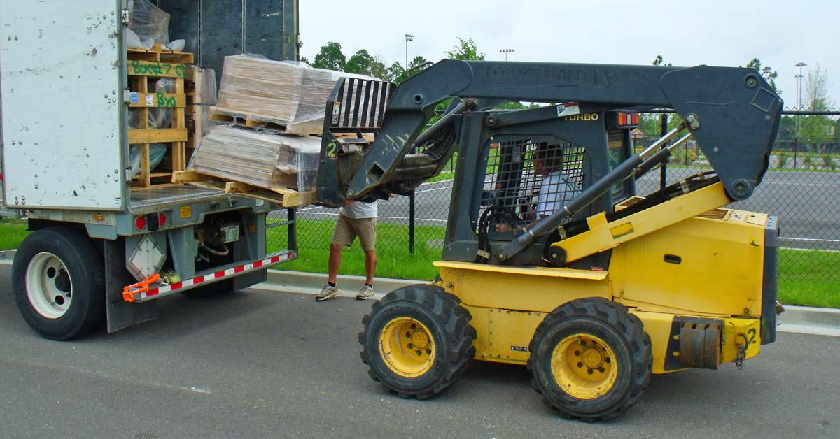 Playground installers unloading equipment from a truck