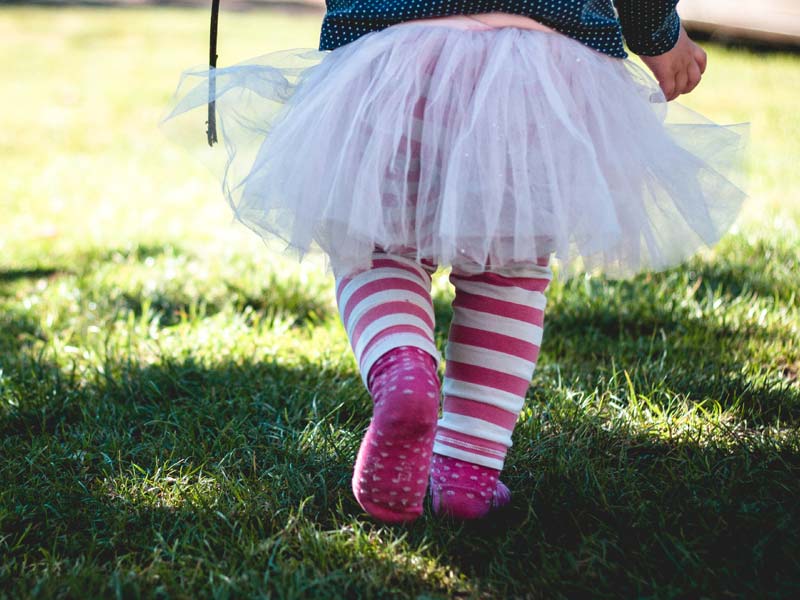 Child shown walking on grass